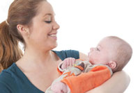 a daycare staff member taking care of a infant.